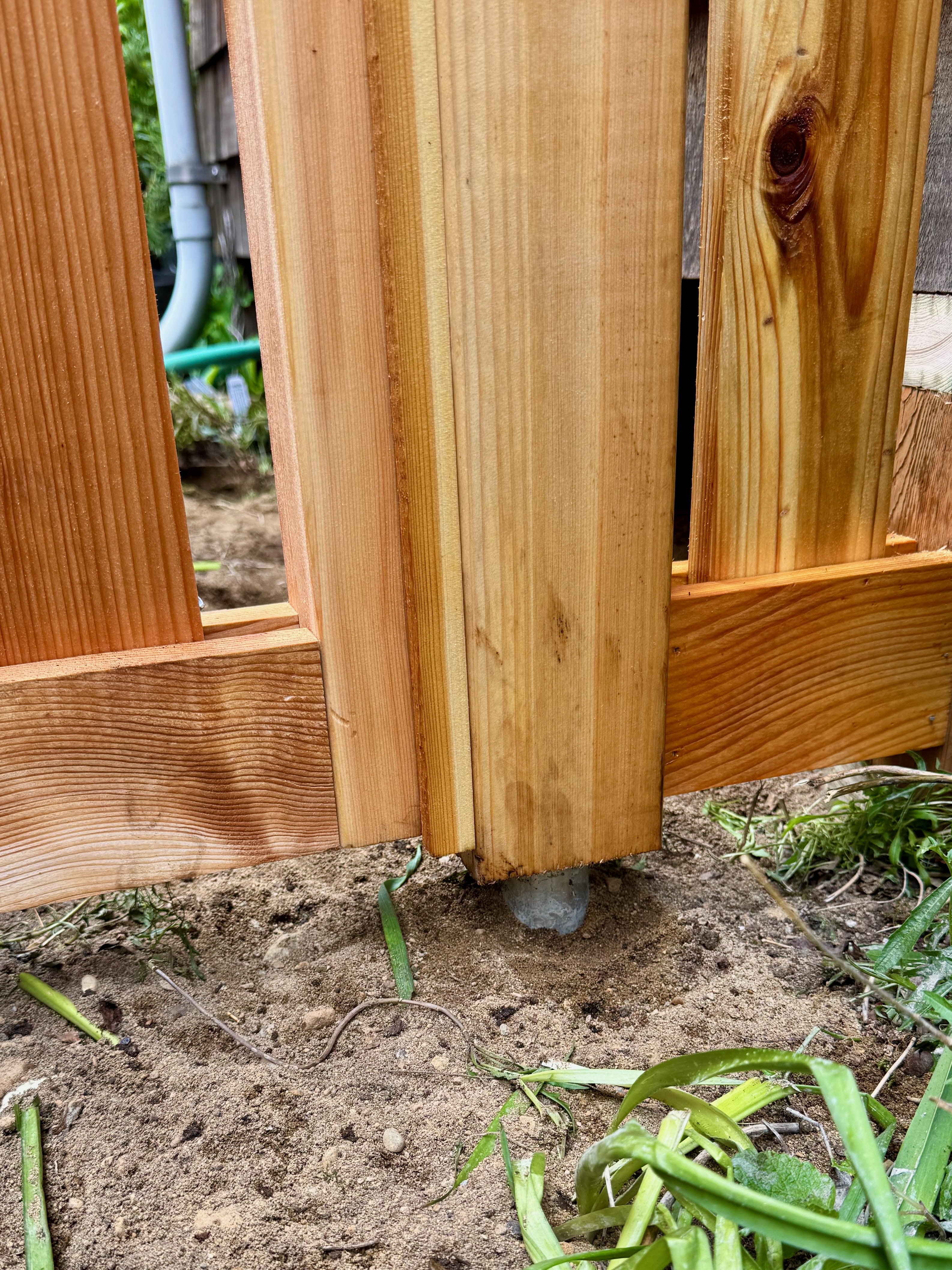 Cedar post mounted on pipe above grade — the right way to do it in a wet climate